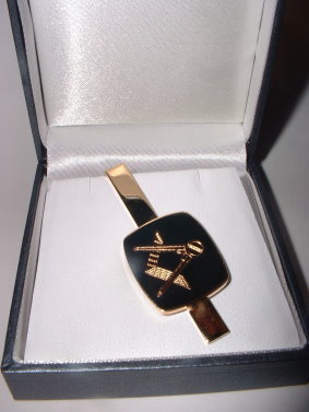 black and gold cufflinks and tie bar